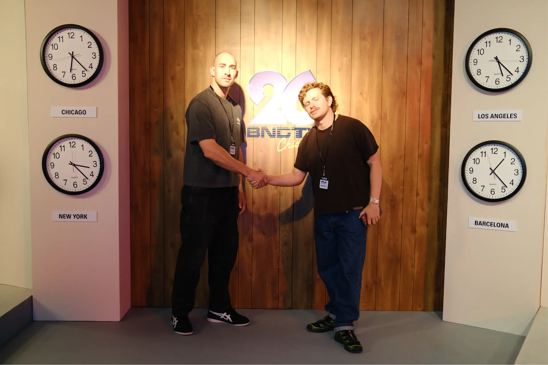 Crew handshake in front of the BNCTV logo