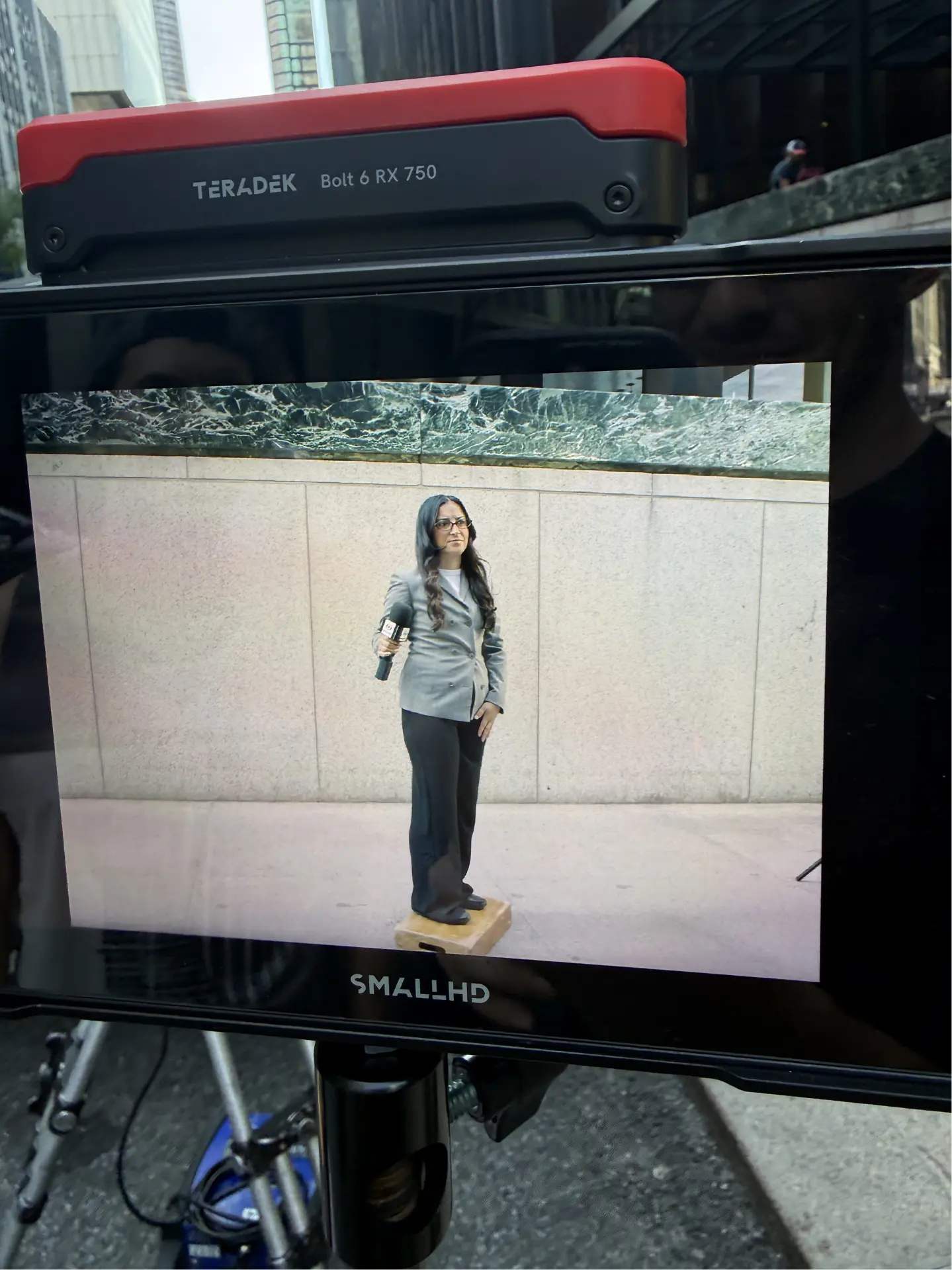 Reporter on a monitor during a street take