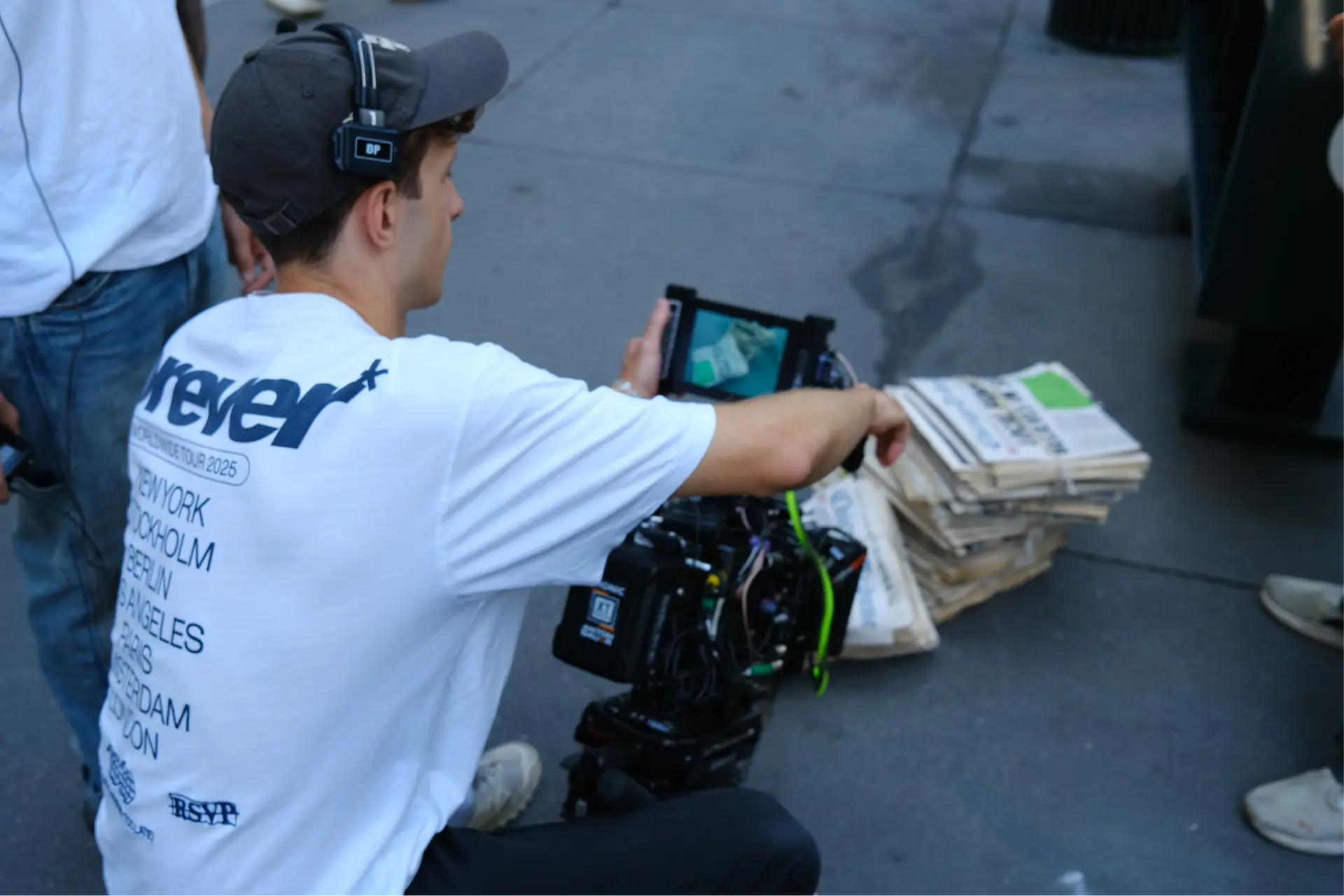Camera operator framing the newspaper stack