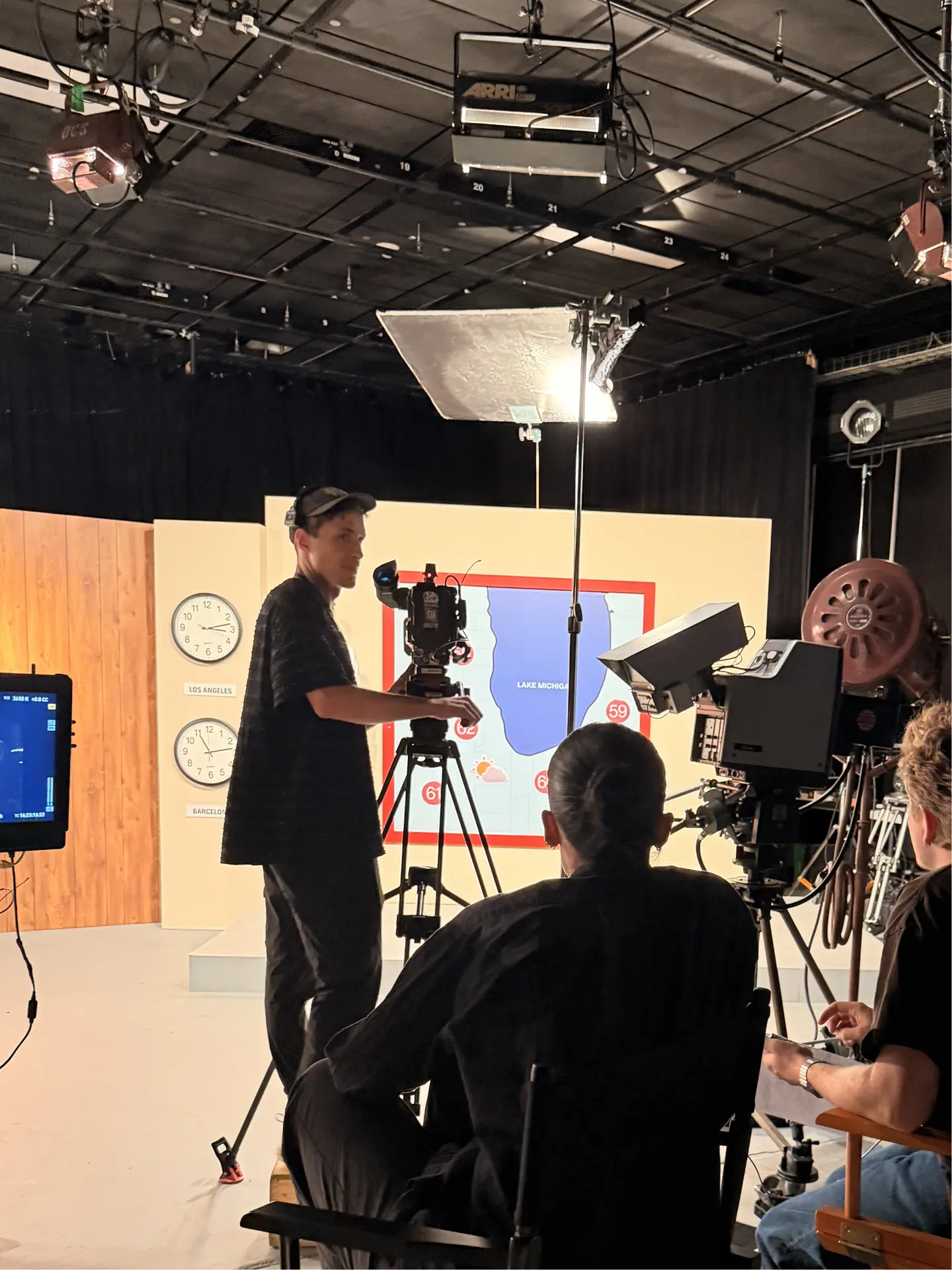 Crew filming in front of the Lake Michigan weather map