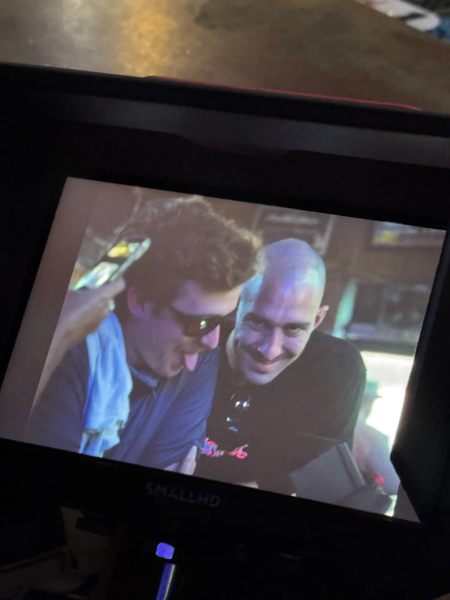 Two crew members goofing around on the monitor