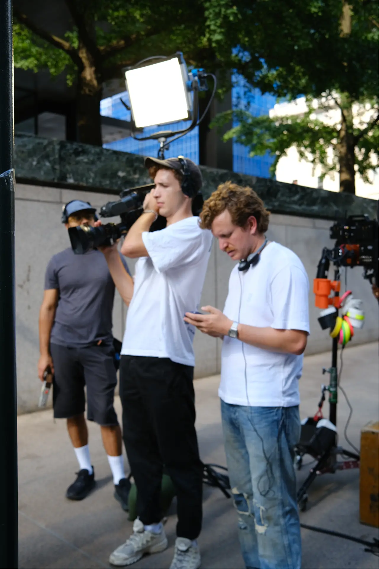Camera operator and crew on the sidewalk